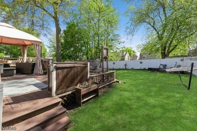 view of yard with a deck, a gazebo, a fenced backyard, and an outdoor hangout area