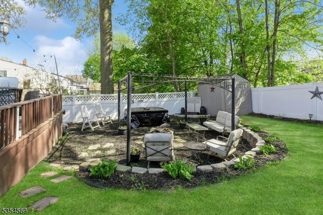 view of yard featuring a fenced backyard, a shed, and an outbuilding