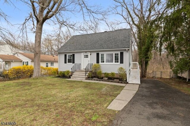 18 Lake Shore Dr, Parsippany-Troy Hills Twp, NJ 07034 - cape cod house with fence, a shingled roof, a front yard, and aphalt driveway