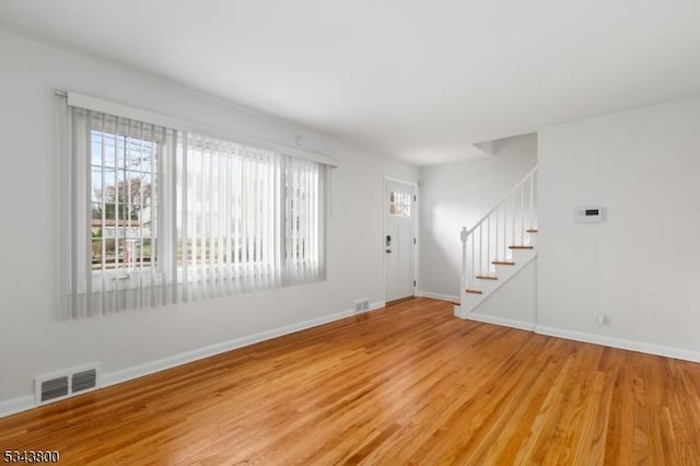 18 Lake Shore Dr, Parsippany-Troy Hills Twp, NJ 07034 - unfurnished living room with stairway, visible vents, baseboards, and light wood finished floors