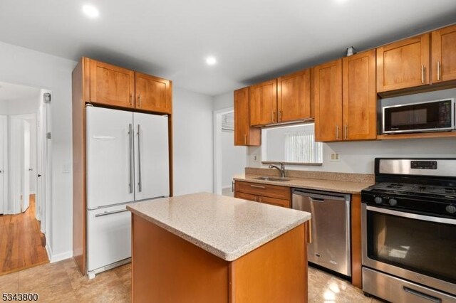 18 Lake Shore Dr, Parsippany-Troy Hills Twp, NJ 07034 - kitchen with brown cabinetry, a center island, recessed lighting, a sink, and appliances with stainless steel finishes