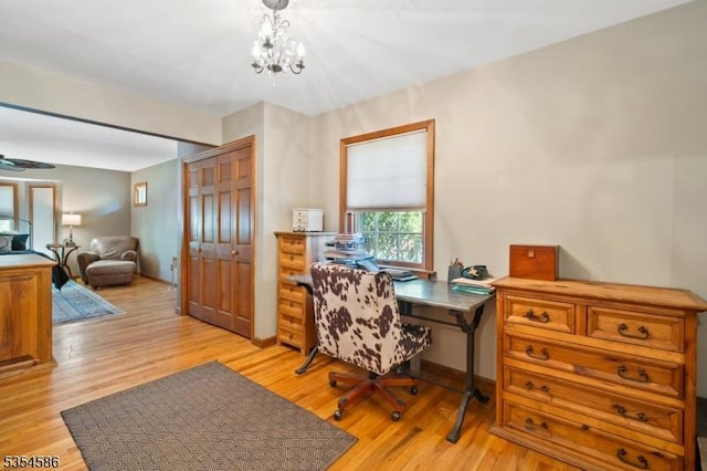 office with an inviting chandelier and light wood finished floors