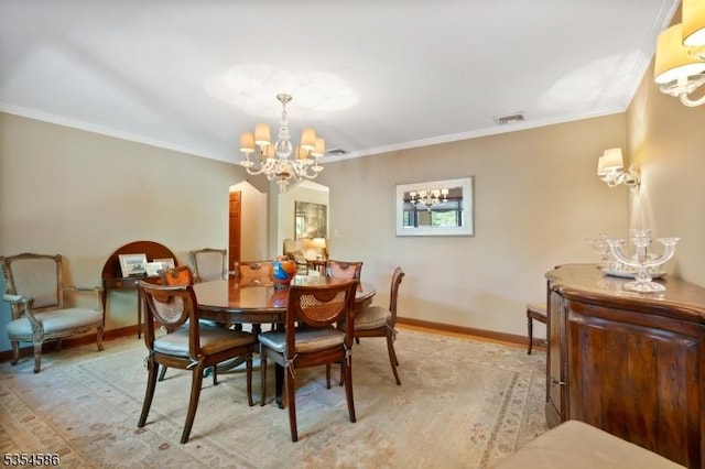 dining room featuring crown molding, baseboards, a notable chandelier, and visible vents