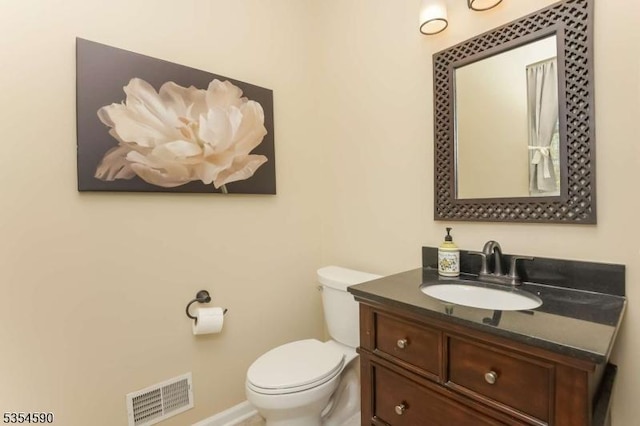 half bathroom featuring visible vents, baseboards, toilet, and vanity