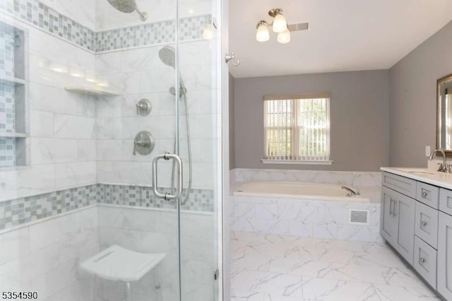 bathroom with visible vents, a garden tub, marble finish floor, and a stall shower