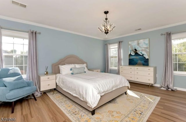 bedroom with visible vents, baseboards, a notable chandelier, ornamental molding, and light wood-style flooring