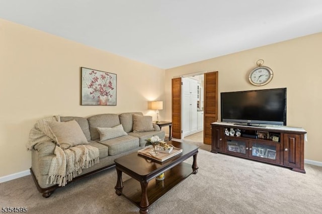 living room featuring carpet floors and baseboards