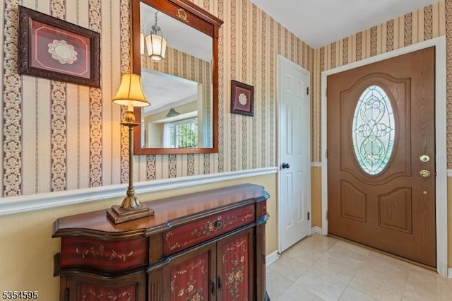 foyer featuring tile patterned floors and wallpapered walls