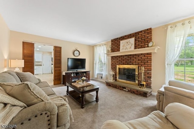 living room with plenty of natural light, carpet flooring, and a brick fireplace