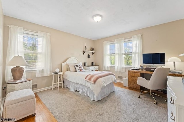 bedroom featuring baseboards and wood finished floors