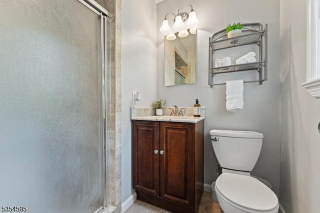 full bathroom with toilet, baseboards, a shower stall, and vanity