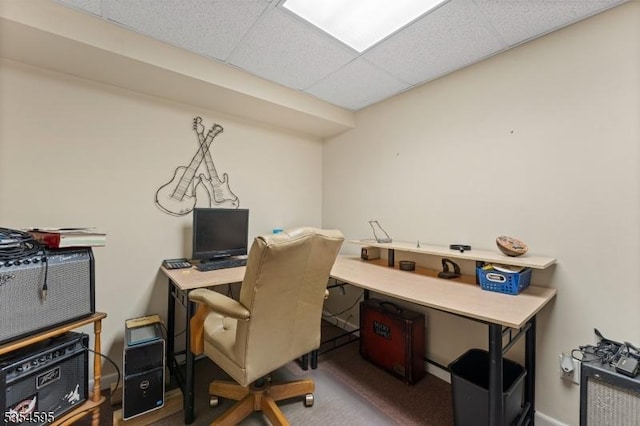 carpeted home office with baseboards and a paneled ceiling