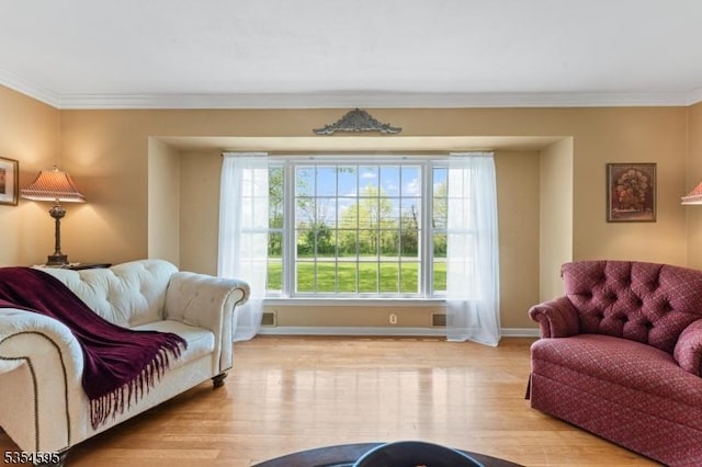 sitting room featuring baseboards, ornamental molding, wood finished floors, and visible vents