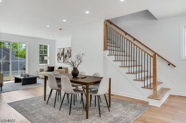 dining space with light wood finished floors, stairway, recessed lighting, and baseboards