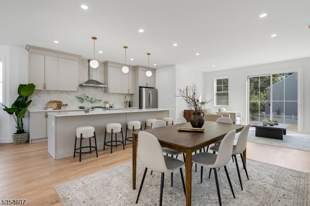 dining space with recessed lighting and light wood-type flooring