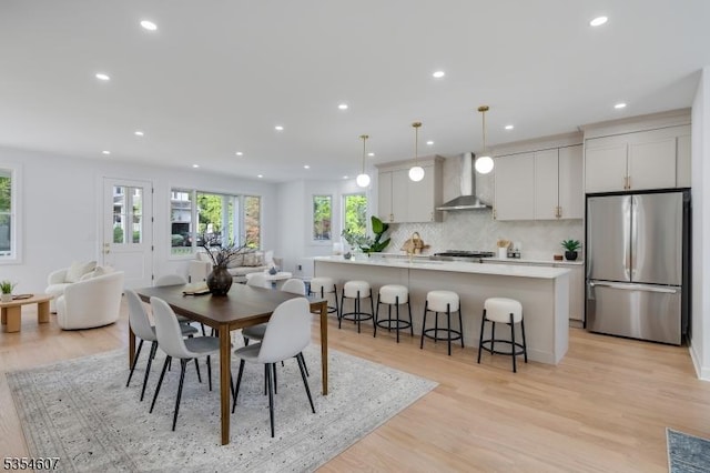 dining area with light wood-style flooring and recessed lighting