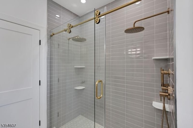 bathroom with a shower stall and recessed lighting
