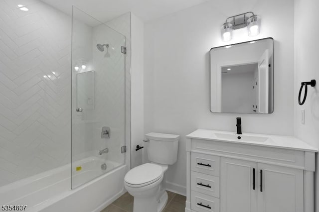 full bath featuring toilet, vanity, baseboards, tub / shower combination, and tile patterned floors