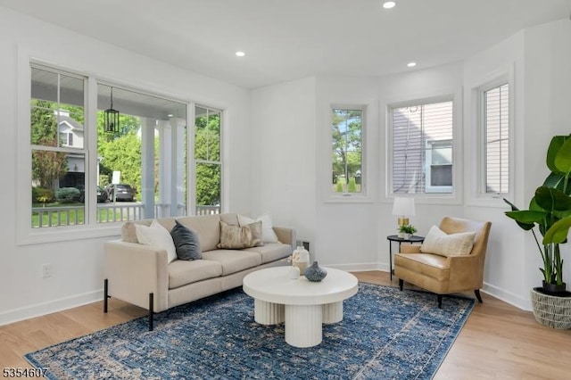 sitting room with wood finished floors, baseboards, and recessed lighting