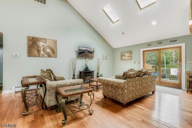 34 Hunter St, Roxbury Twp, NJ 07876 - living area with high vaulted ceiling, a skylight, and light wood-style floors