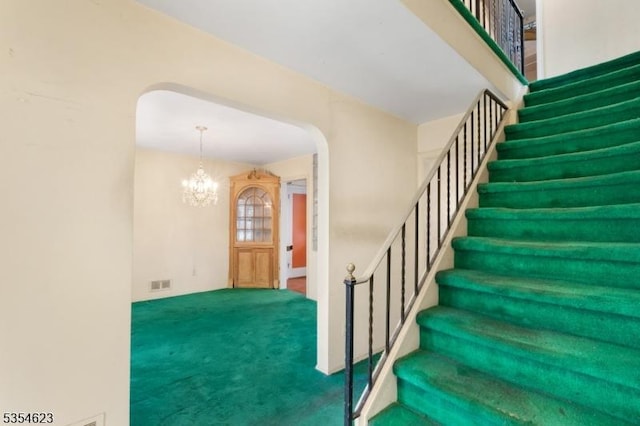 630 Ridgewood Rd, Maplewood Twp, NJ 07040 - stairway with an inviting chandelier, arched walkways, carpet flooring, and visible vents