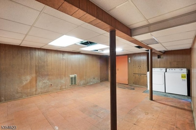 630 Ridgewood Rd, Maplewood Twp, NJ 07040 - finished below grade area with visible vents, wood walls, a drop ceiling, and washer and dryer