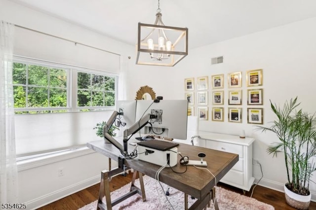 office featuring baseboards, visible vents, dark wood finished floors, and a chandelier