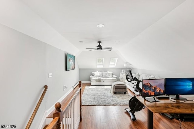 living room featuring a ceiling fan, wood finished floors, and lofted ceiling