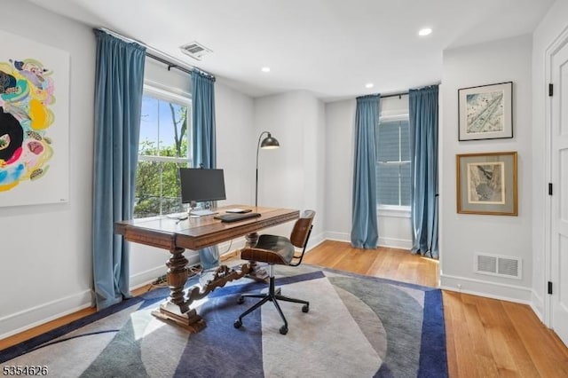 office featuring visible vents, recessed lighting, baseboards, and wood finished floors