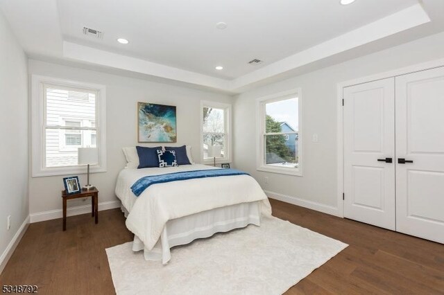 553 Thoreau Ter, Union Twp, NJ 07083 - bedroom featuring baseboards, a tray ceiling, and dark wood-style floors