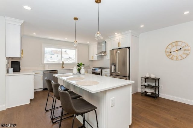 553 Thoreau Ter, Union Twp, NJ 07083 - kitchen featuring dark wood-style flooring, wall chimney exhaust hood, appliances with stainless steel finishes, and white cabinetry