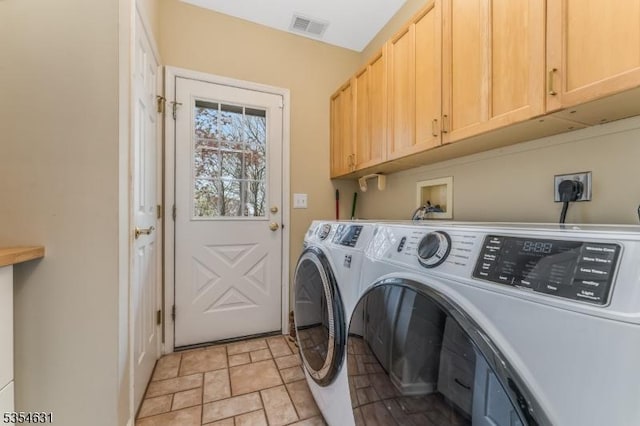 clothes washing area with stone finish floor, independent washer and dryer, cabinet space, and visible vents