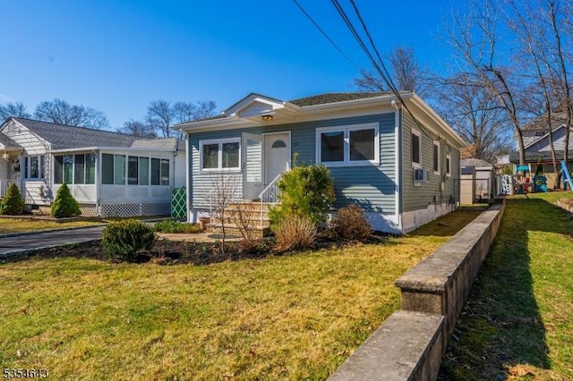 bungalow-style home featuring entry steps and a front yard