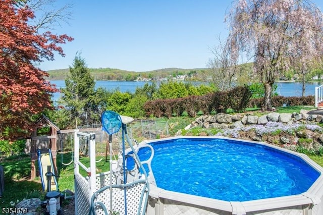 view of pool featuring a water view