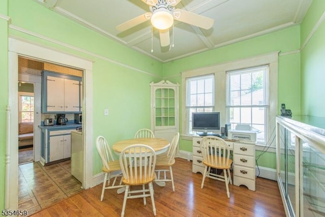 dining area featuring baseboards, ceiling fan, and wood finished floors