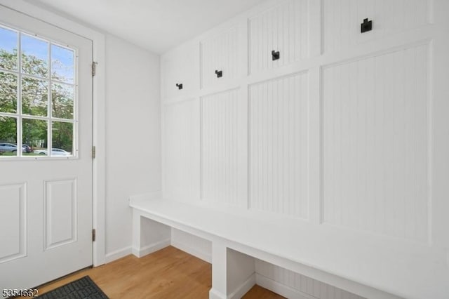 mudroom featuring baseboards and light wood finished floors