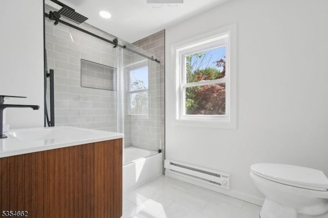 full bathroom featuring tile patterned flooring, baseboard heating, vanity, toilet, and enclosed tub / shower combo