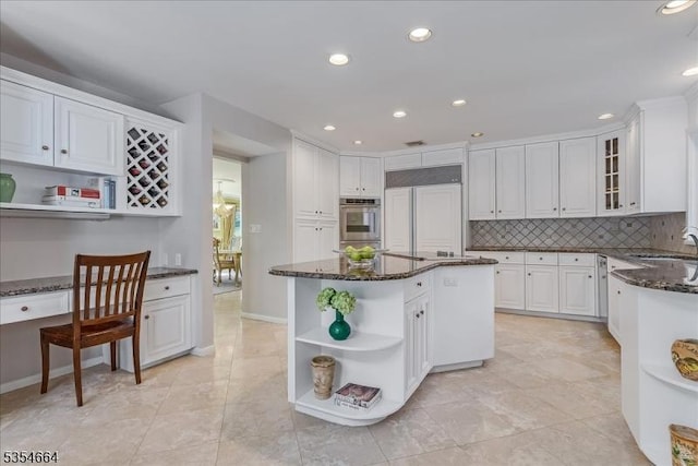 kitchen featuring open shelves, dark stone counters, white cabinets, built in fridge, and recessed lighting