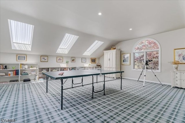 rec room with carpet, baseboards, lofted ceiling with skylight, and recessed lighting