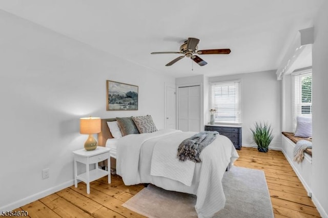 bedroom featuring baseboards, ceiling fan, and light wood-type flooring