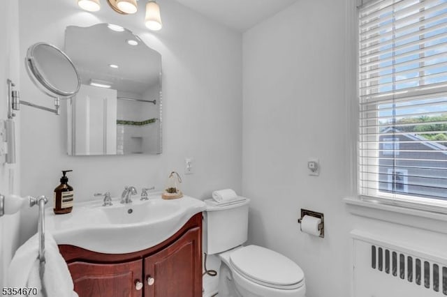 bathroom featuring vanity, radiator, and toilet