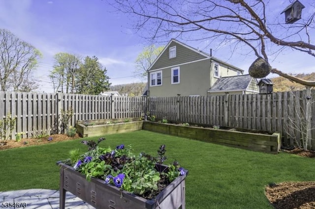 view of yard featuring a fenced backyard and a vegetable garden