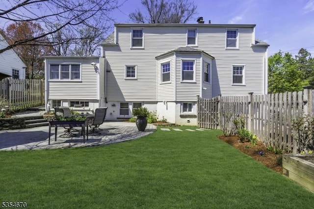 rear view of property with a lawn, fence, and a patio area