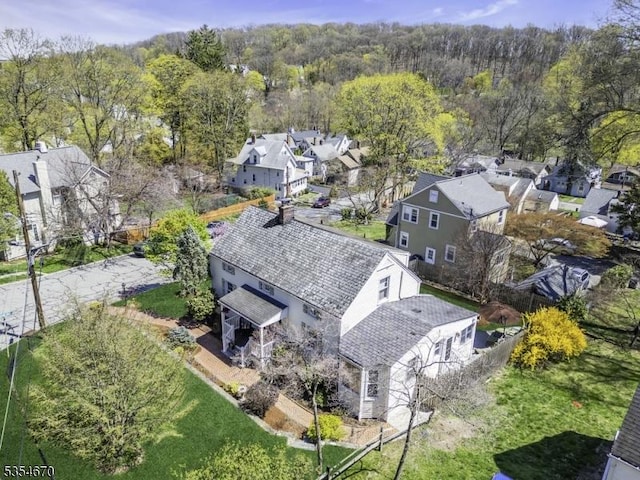birds eye view of property with a residential view and a view of trees