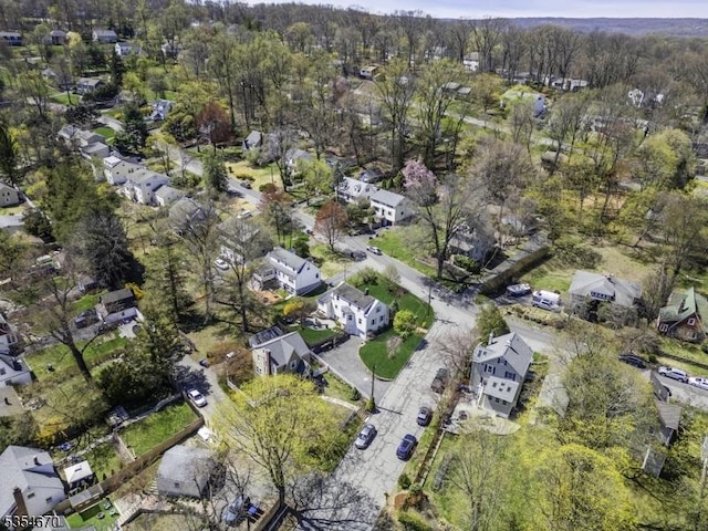birds eye view of property featuring a view of trees and a residential view