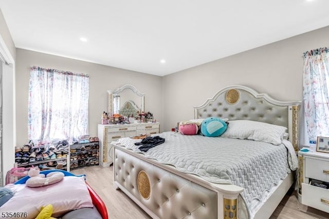 bedroom with light wood finished floors and recessed lighting
