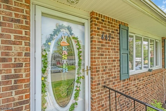 view of side of property with brick siding and covered porch