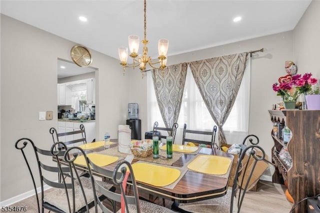 dining room featuring a chandelier, light wood finished floors, recessed lighting, and baseboards