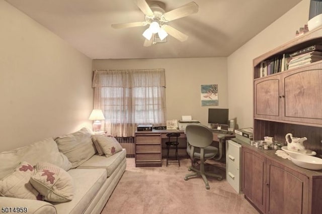 office with radiator heating unit, ceiling fan, and light colored carpet