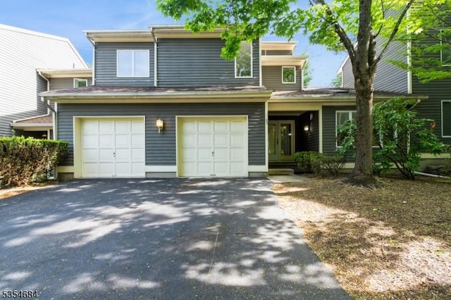 view of front of property featuring a garage and aphalt driveway